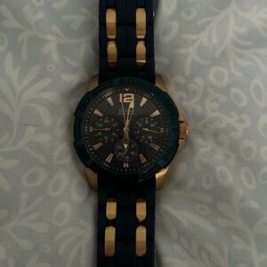 Men’s gold and blue guess watch